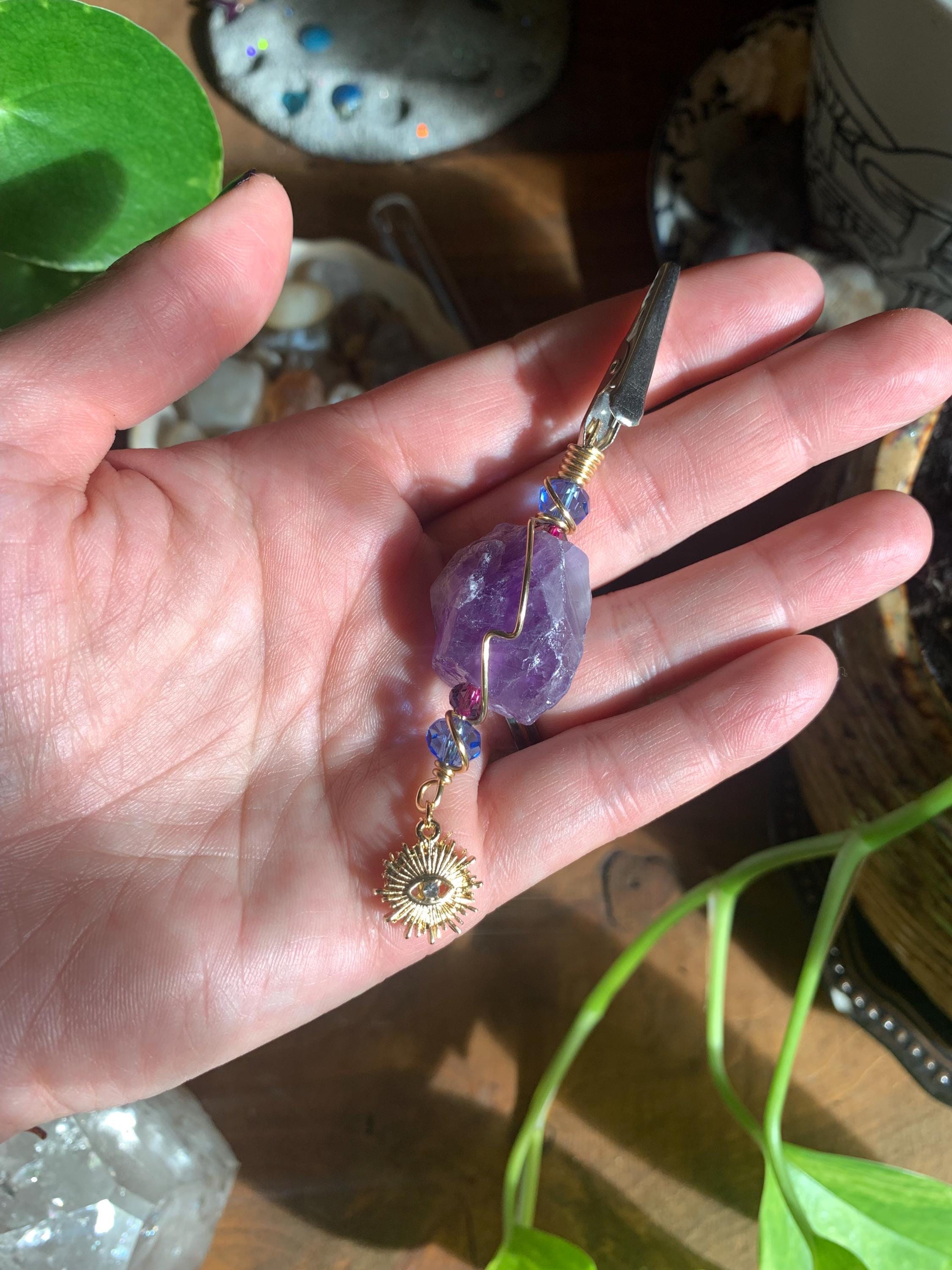 Raw Amethyst Smoke Clip with purple and blue glass beads, gold wire, evil eye, sun charm
