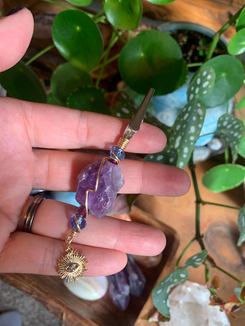 Raw Amethyst Smoke Clip with purple and blue glass beads, gold wire, evil eye, sun charm